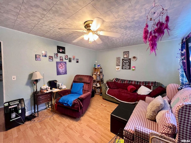 living room with wood-type flooring and ceiling fan