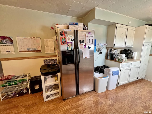 1106 N 11th St, Murphysboro, IL 62966 - kitchen featuring stainless steel fridge with ice dispenser, white cabinetry, light wood-type flooring, and ornamental molding