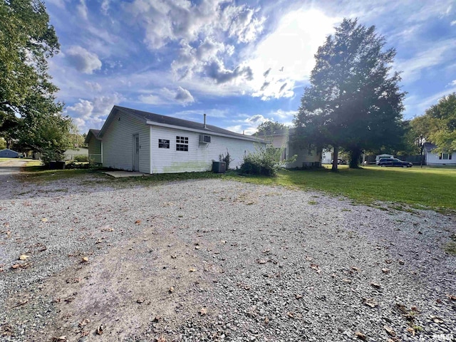 1106 N 11th St, Murphysboro, IL 62966 - back of property with central AC unit, a lawn, and driveway