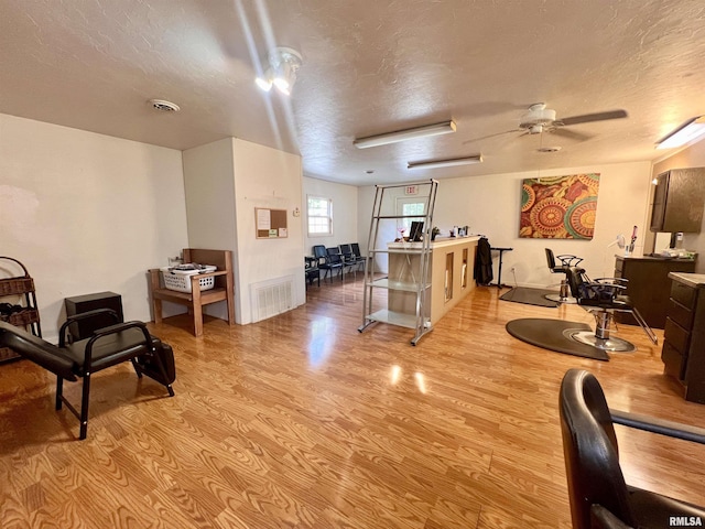 1106 N 11th St, Murphysboro, IL 62966 - interior space with a textured ceiling, visible vents, light wood-style floors, and a ceiling fan
