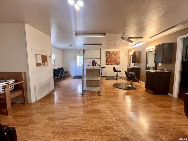 1106 N 11th St, Murphysboro, IL 62966 - interior space with a textured ceiling, baseboards, visible vents, light wood-style floors, and ceiling fan