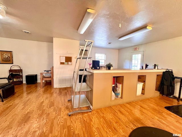 kitchen featuring light wood-type flooring and a textured ceiling