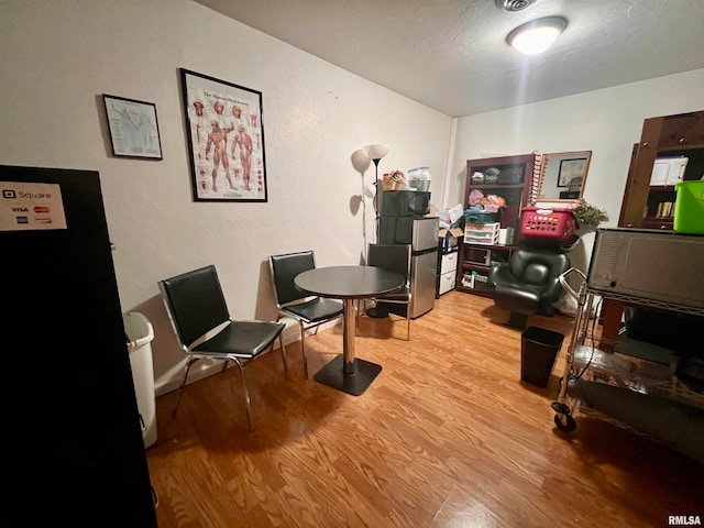 home office with light hardwood / wood-style floors