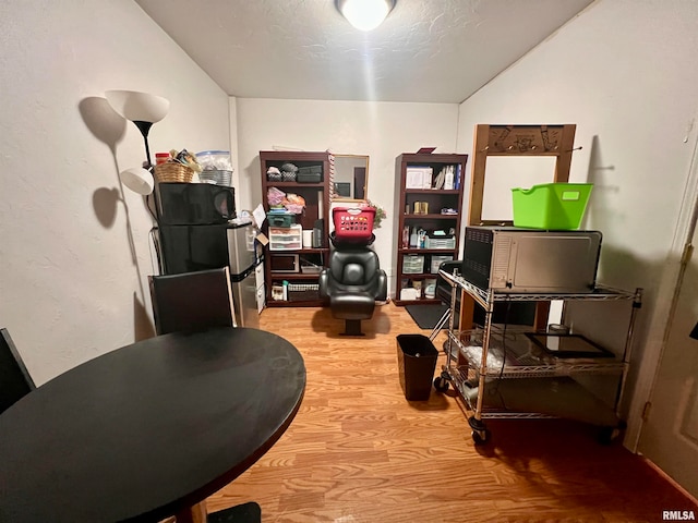 office featuring wood-type flooring and lofted ceiling