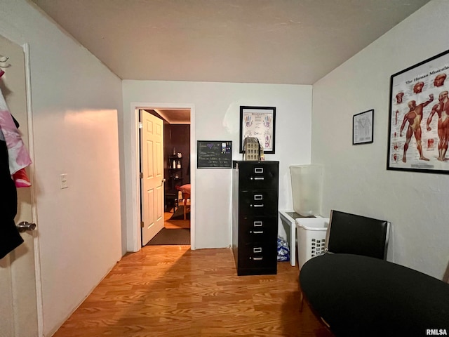 home office with light hardwood / wood-style flooring