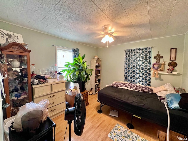 bedroom featuring light hardwood / wood-style flooring and ceiling fan