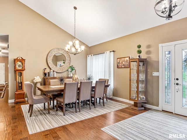 dining area featuring wood-type flooring, a chandelier, and a healthy amount of sunlight