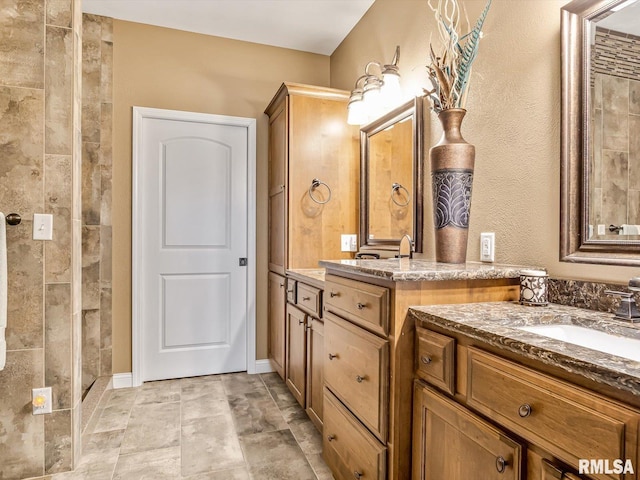 bathroom with vanity and a shower with shower door