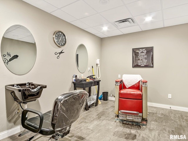 office area featuring hardwood / wood-style flooring and a paneled ceiling