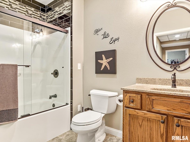 full bathroom with enclosed tub / shower combo, vanity, and toilet