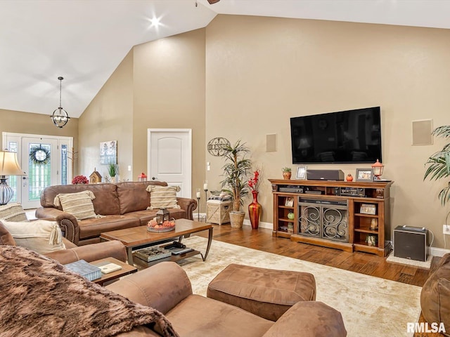 living room featuring hardwood / wood-style flooring and high vaulted ceiling