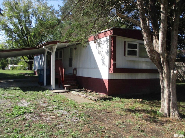 view of side of home with a carport