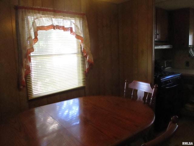 dining area featuring wood walls