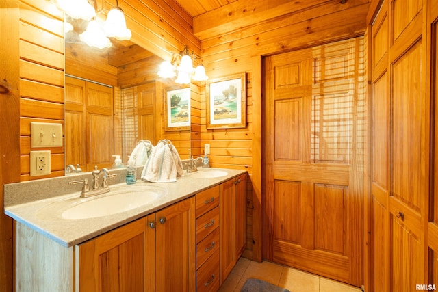 full bathroom with tile patterned flooring, double vanity, wood walls, and a sink