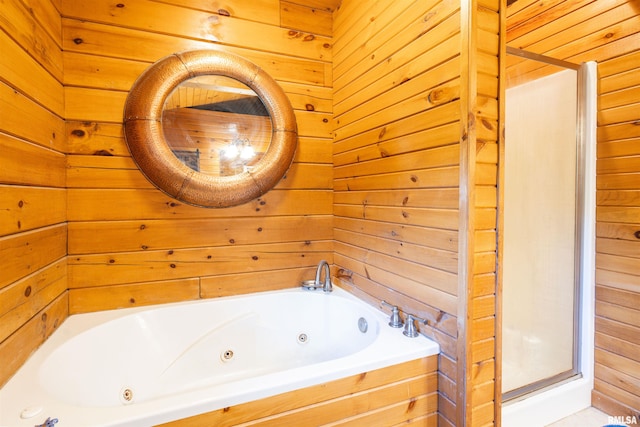 full bathroom with a jetted tub and wood walls