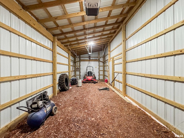 garage featuring a garage door opener and metal wall