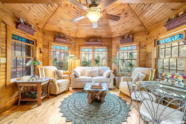 sunroom / solarium with ceiling fan, wooden ceiling, and vaulted ceiling