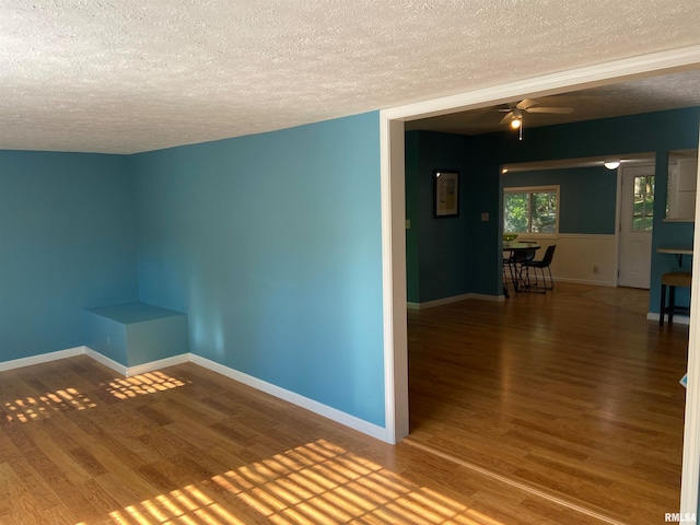 unfurnished room featuring ceiling fan, a textured ceiling, and hardwood / wood-style floors