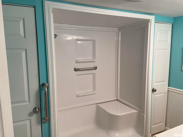 bathroom featuring a textured ceiling and a shower