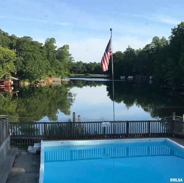 view of pool featuring a water view