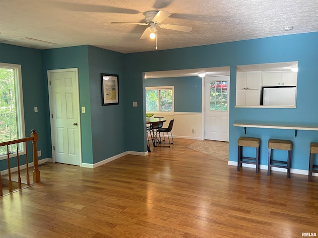 interior space featuring a textured ceiling, ceiling fan, and hardwood / wood-style flooring