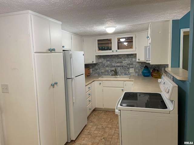 kitchen with white cabinets, backsplash, white appliances, a textured ceiling, and sink