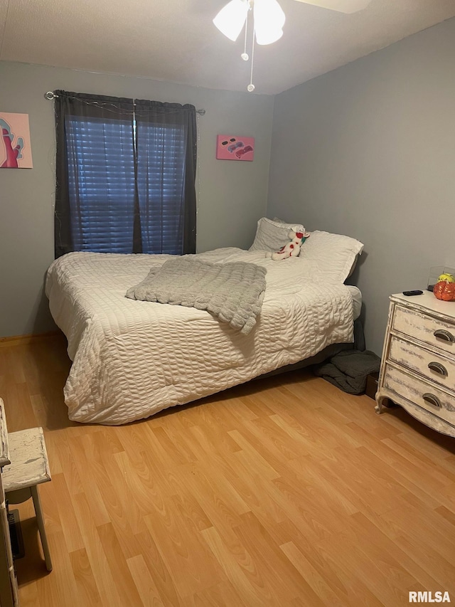 bedroom with light wood-type flooring and ceiling fan