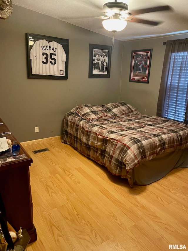 bedroom featuring light wood-type flooring and ceiling fan