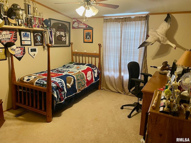 bedroom featuring light carpet, ceiling fan, ornamental molding, and a textured ceiling