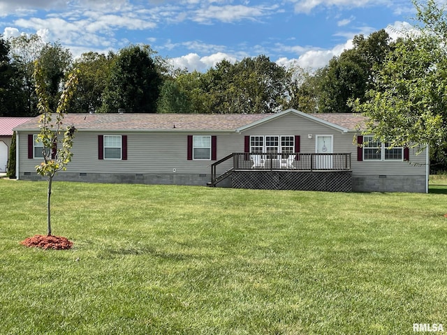 view of front of home featuring a deck and a front lawn