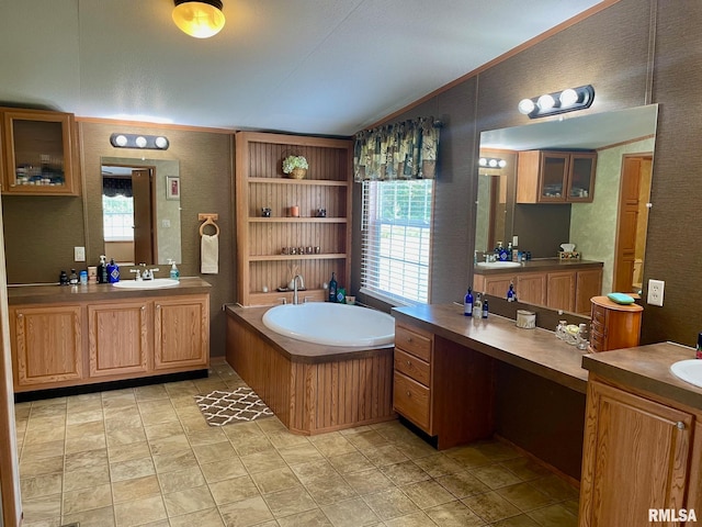 bathroom featuring ornamental molding, a bathing tub, and vanity