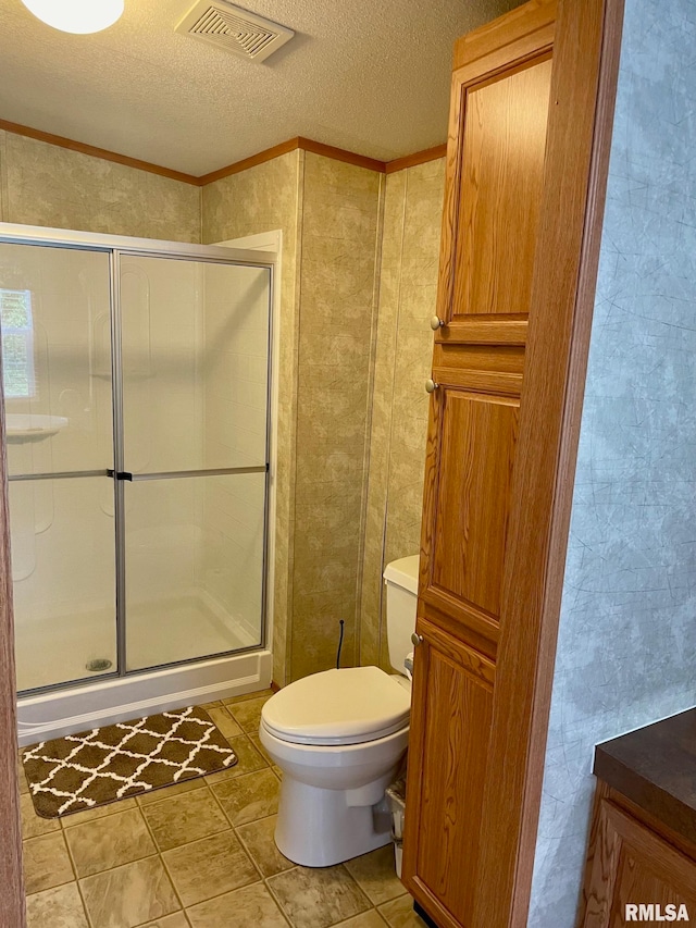 bathroom featuring walk in shower, vanity, toilet, and a textured ceiling