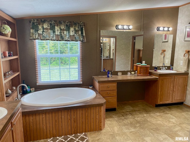 bathroom with a bathtub, a textured ceiling, and vanity