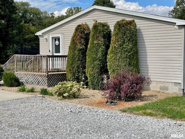 view of property exterior with a deck