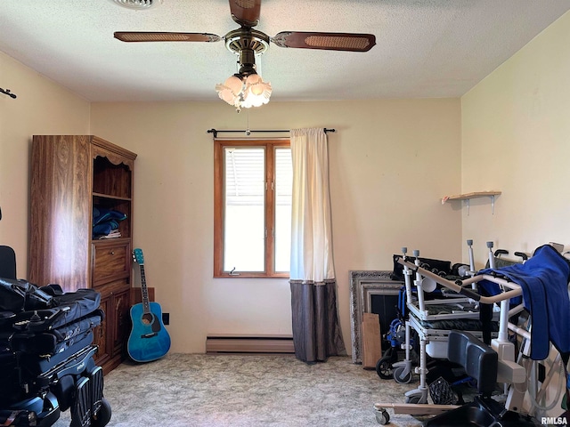 home office with a textured ceiling, a baseboard heating unit, ceiling fan, and light colored carpet