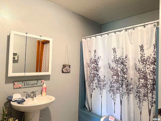 bathroom featuring shower / bathtub combination with curtain and sink