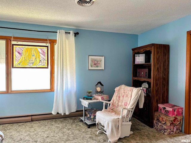 sitting room featuring a textured ceiling, a baseboard radiator, and carpet flooring