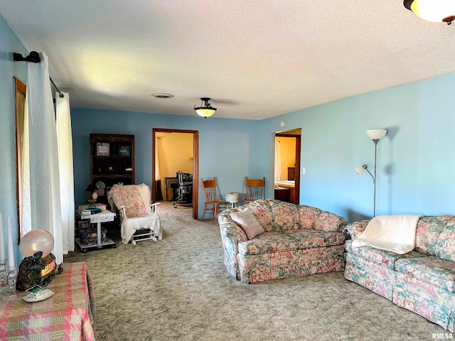 carpeted living room featuring a textured ceiling