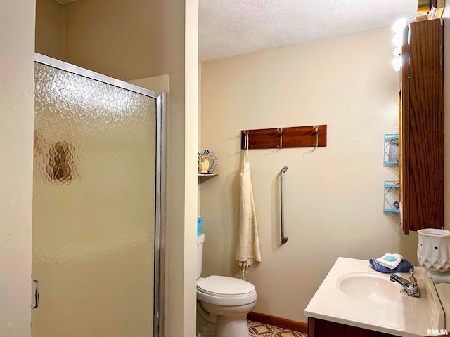 bathroom with a textured ceiling, vanity, toilet, and an enclosed shower