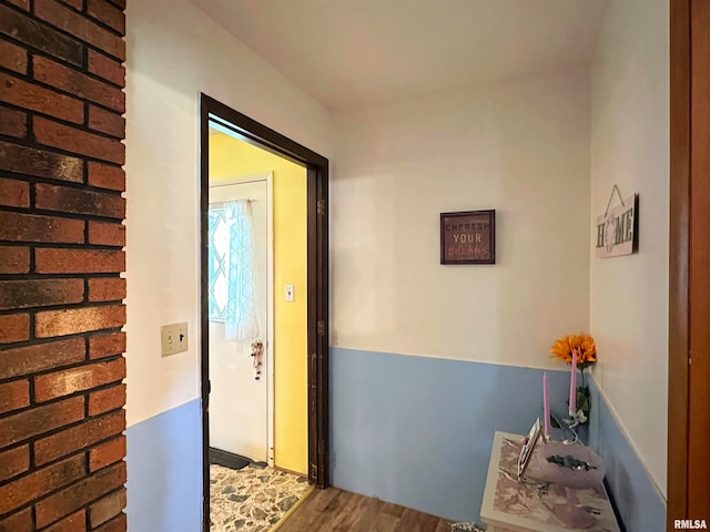 hallway with hardwood / wood-style floors