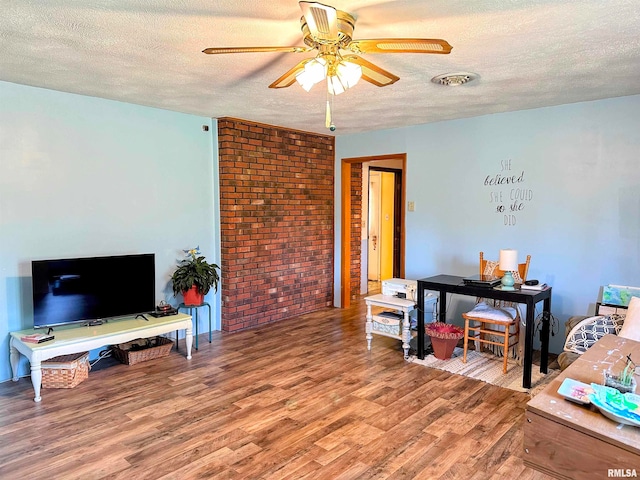 office space with wood-type flooring, a textured ceiling, and ceiling fan