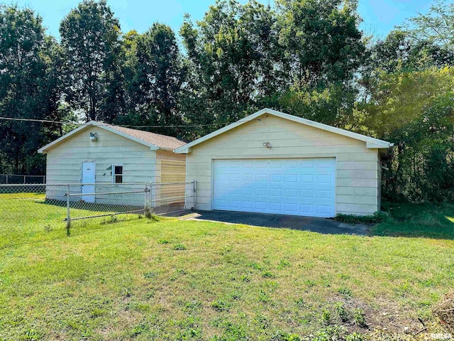 garage with a lawn and wood walls