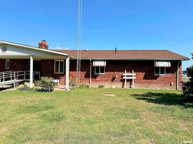 back of property featuring a yard