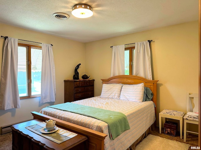 carpeted bedroom featuring a textured ceiling