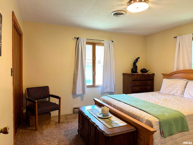 bedroom featuring a textured ceiling and carpet floors