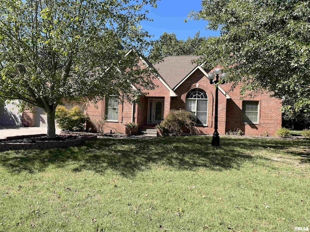 view of front of property featuring a front lawn and brick siding