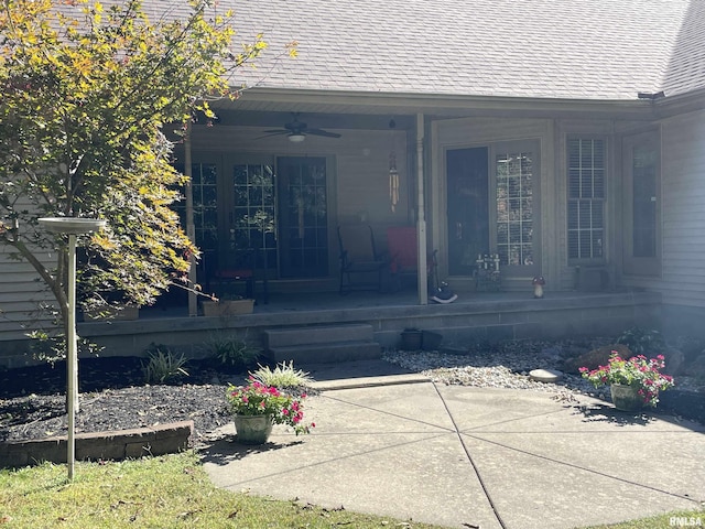 property entrance featuring a porch, a ceiling fan, and roof with shingles