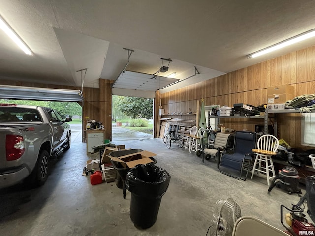 garage featuring wood walls and a garage door opener