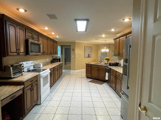 kitchen with pendant lighting, a notable chandelier, appliances with stainless steel finishes, light tile patterned floors, and ornamental molding