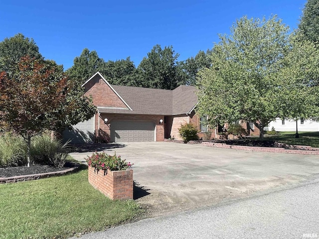 view of front of property with brick siding, a front lawn, a garage, and concrete driveway
